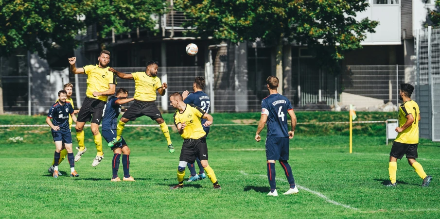 a group of young men playing soccer on a lush green field