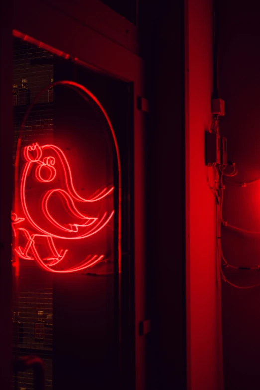a red neon sign that is on a door