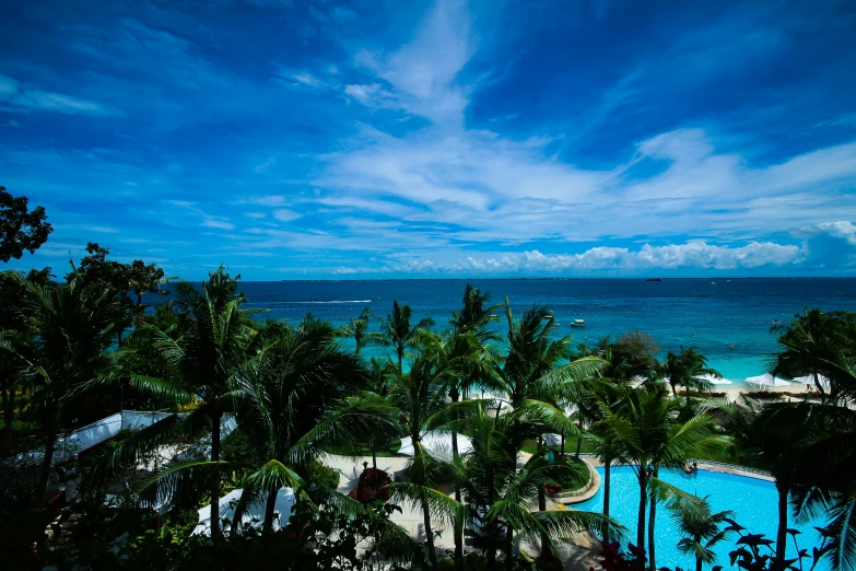 a tropical resort is next to the ocean