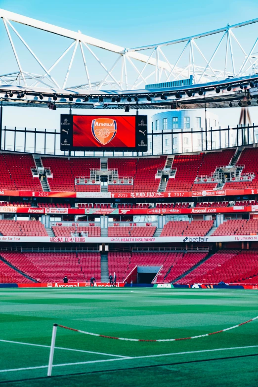 an empty stadium stands in the distance for a soccer team