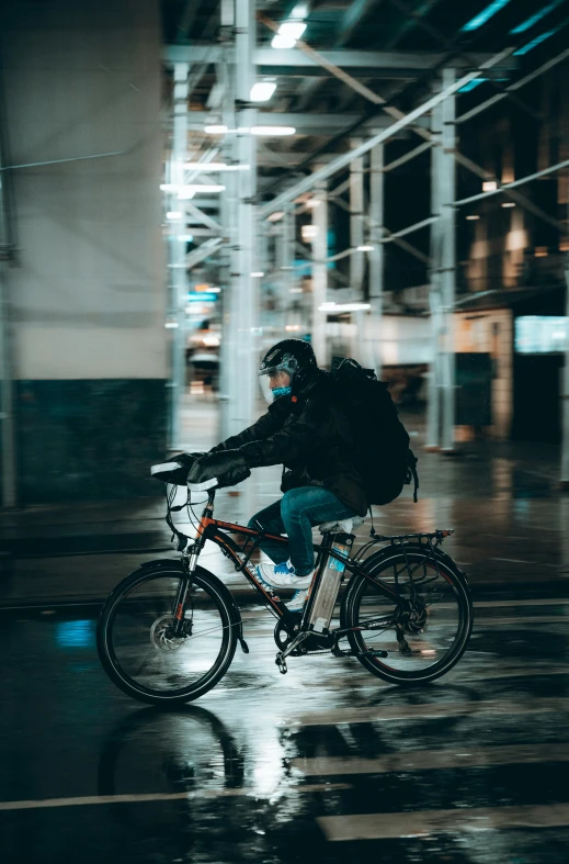 a person riding a bicycle in the rain