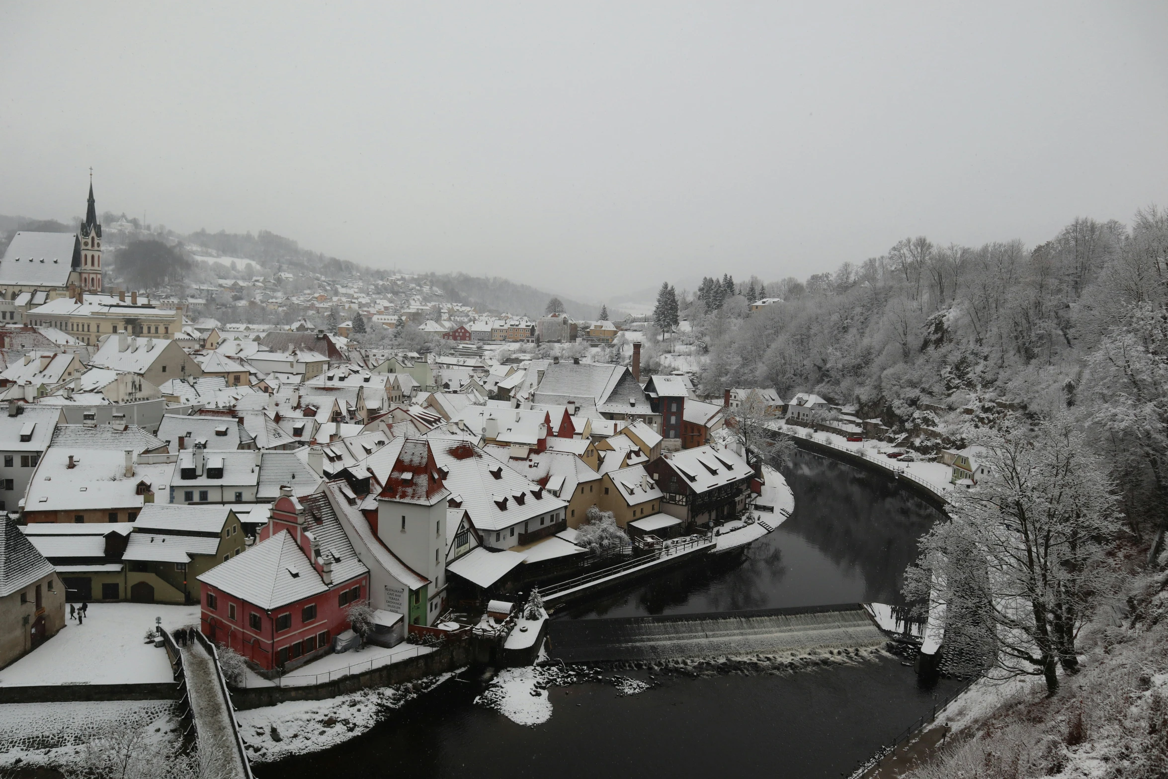 snowy day in the old town near the river