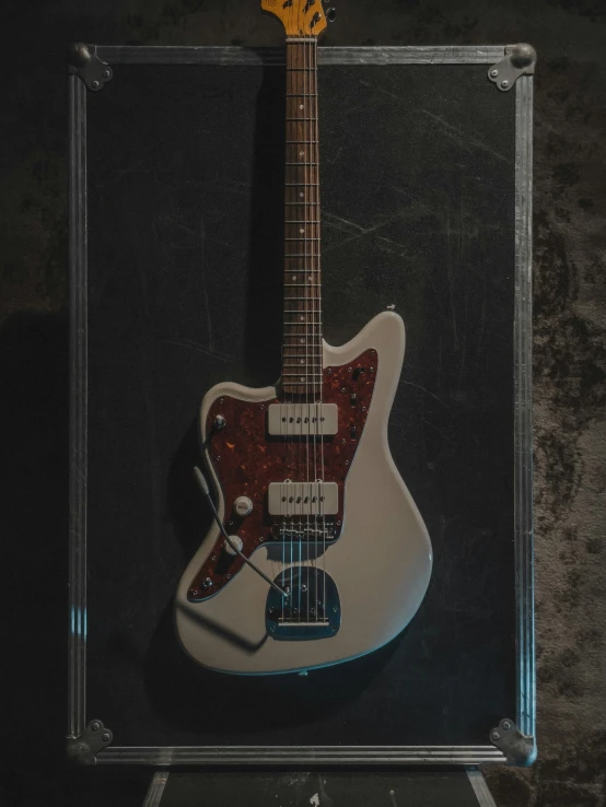 a close up of an electric guitar in a case