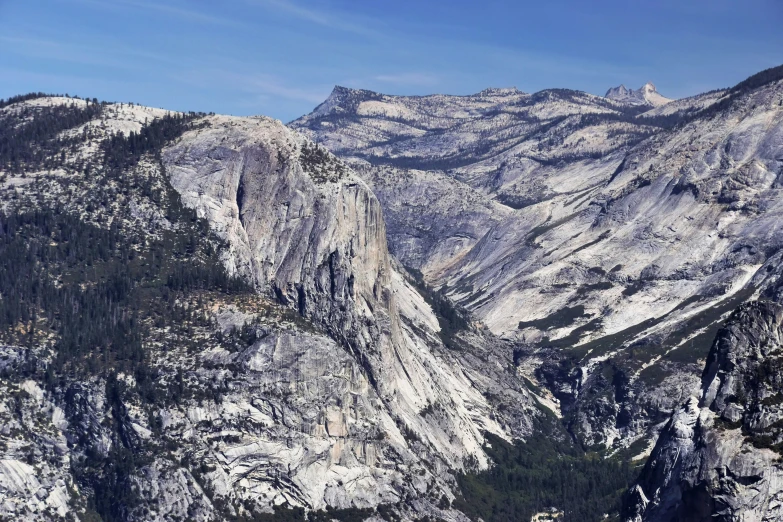 a mountain view of trees and mountains with no leaves