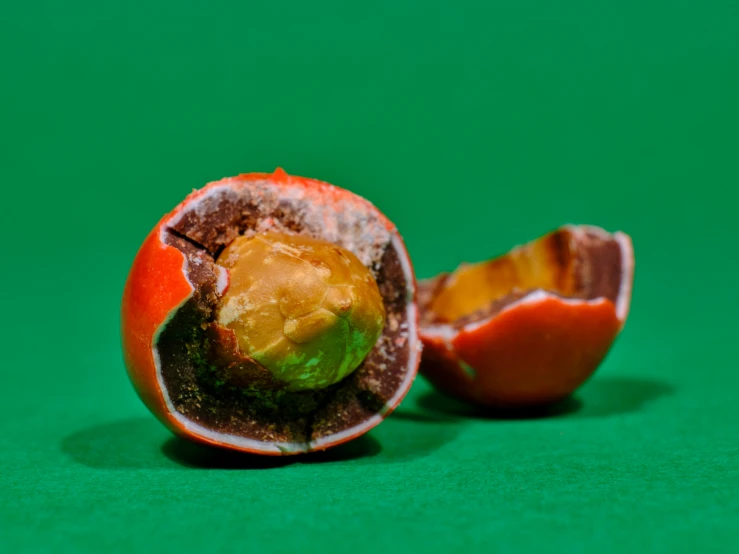 an open orange next to a half eaten orange