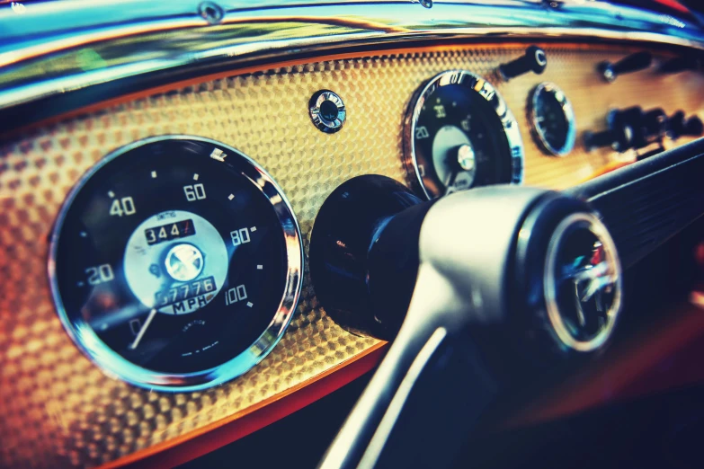 a gauge and thermometer are located on the dashboard