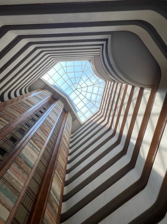 a room with several windows and blinds that look up