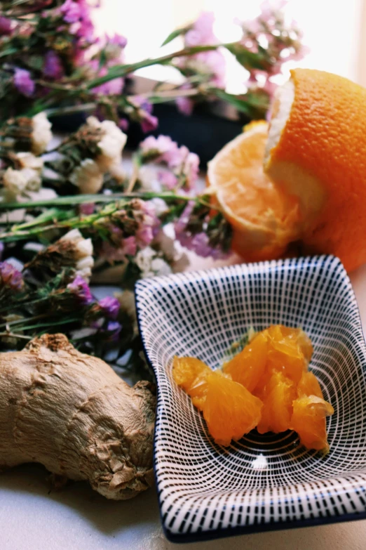 an orange sitting in a bowl on a table