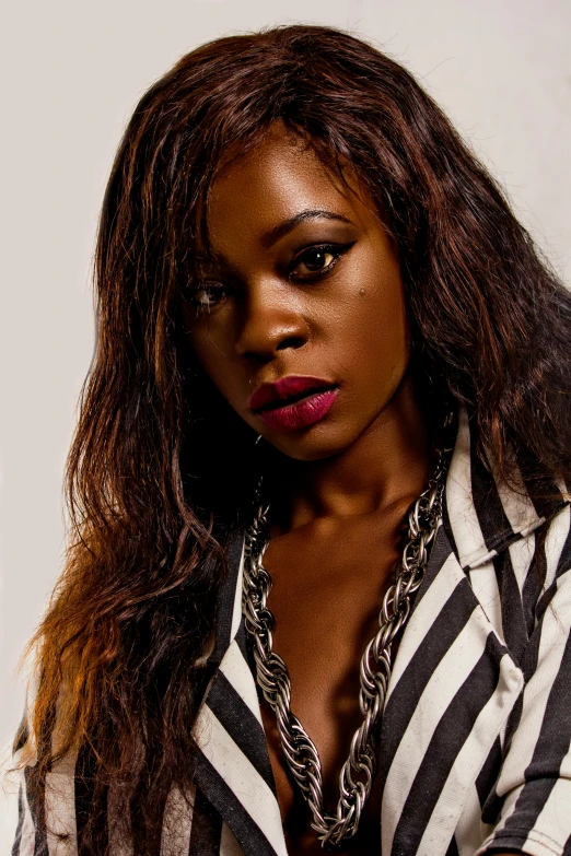 a woman poses for a po in a striped shirt