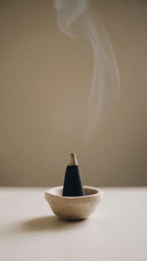 a picture of a bowl on a table next to a cup with some type of substance in it