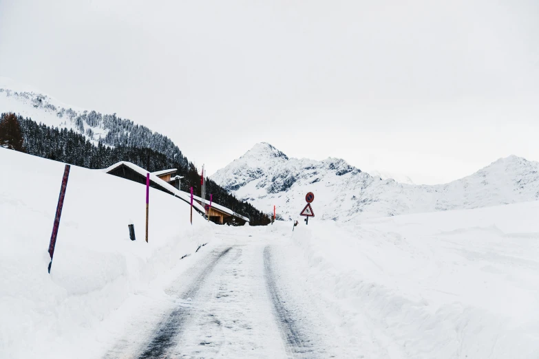 snow is falling and some road signs and lights