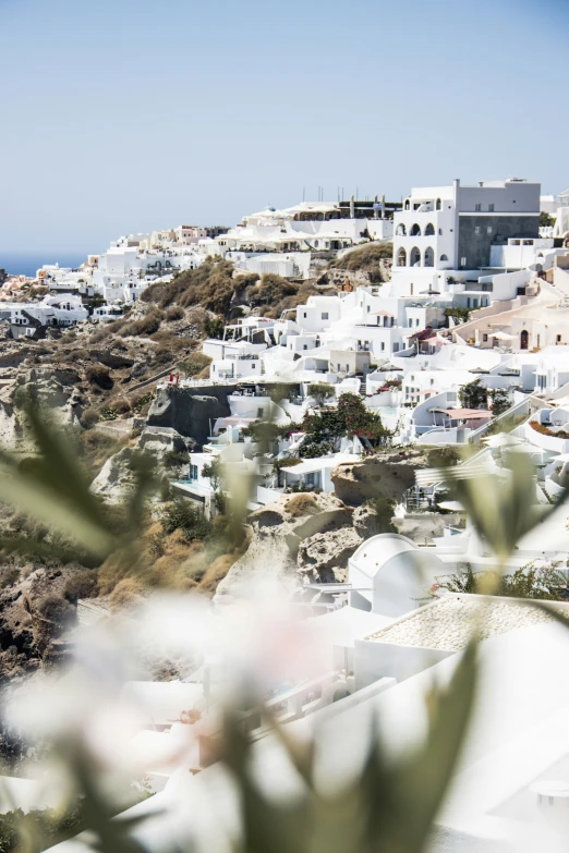 some white buildings on top of a hill in a city