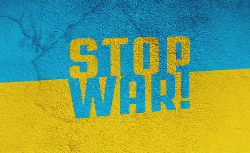 a blue, yellow and black towel that says stop war