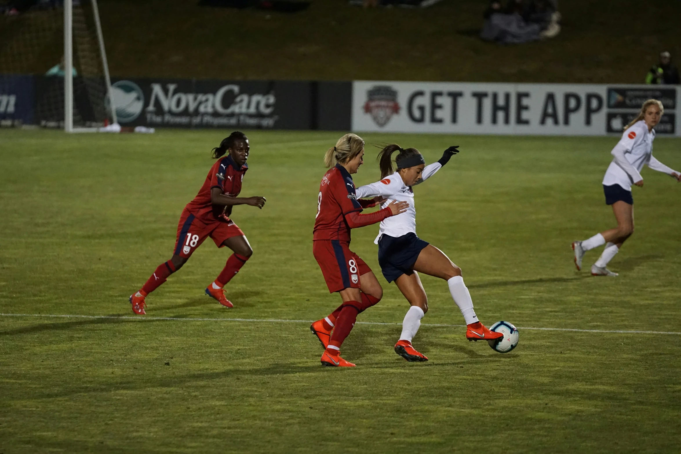 a group of people playing a game of soccer