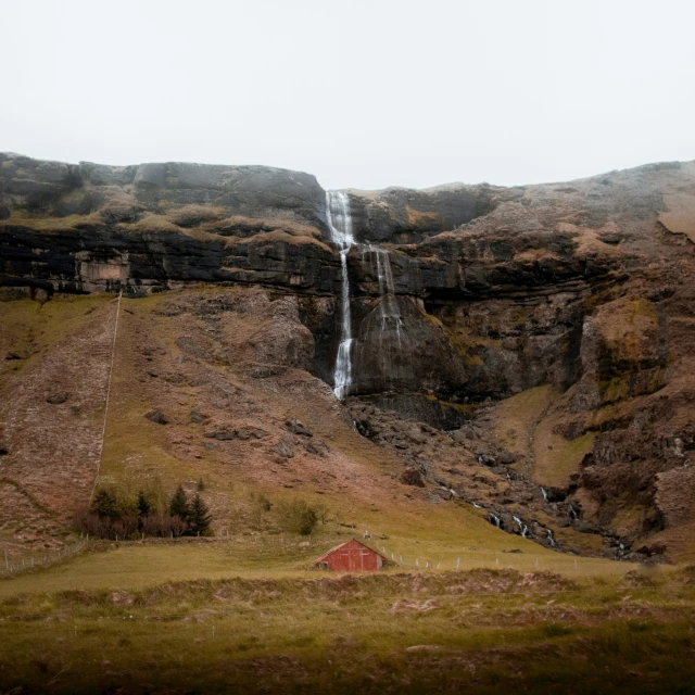 there is a waterfall located at the top of the hill