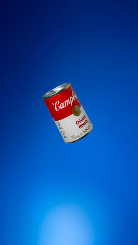 a can flying in the air over blue background