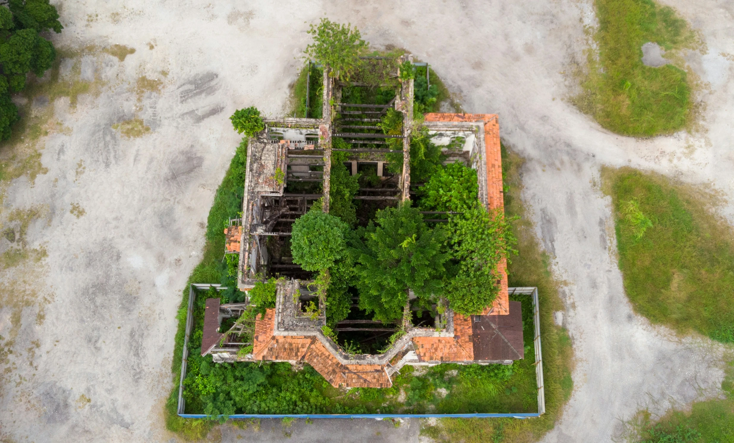 an aerial view of a home that has grass growing on the roof