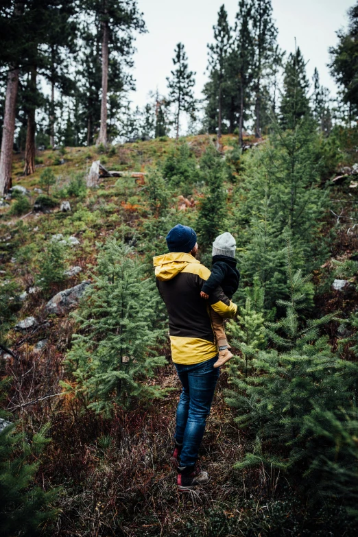 the two people are carrying each other on a hill