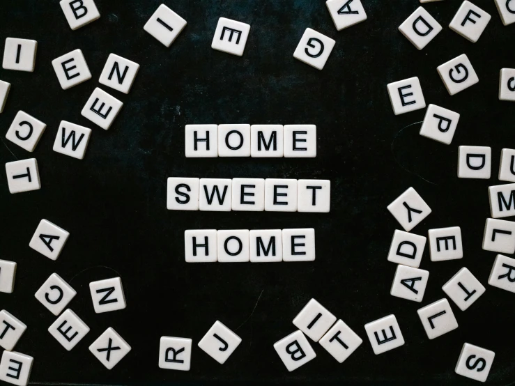 scrabbled tiles and letters that spell out the word home