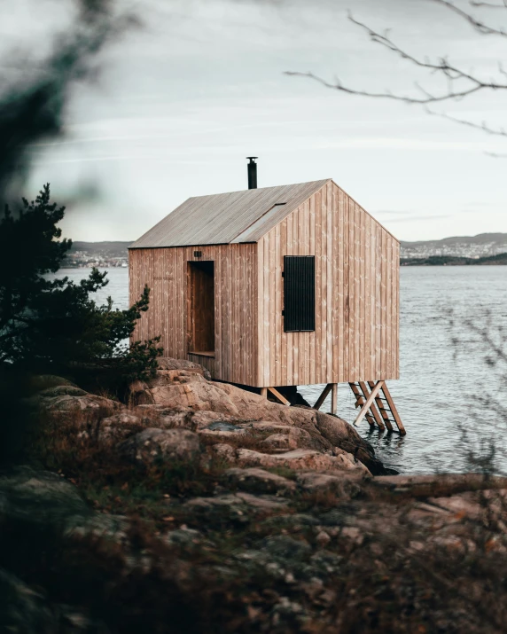 an outhouse sits on a small island