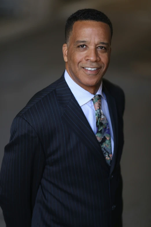 a close up of a man in a suit and tie