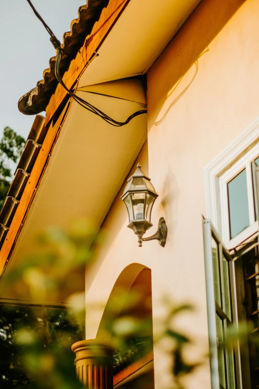 a light hangs on a wall above an entrance