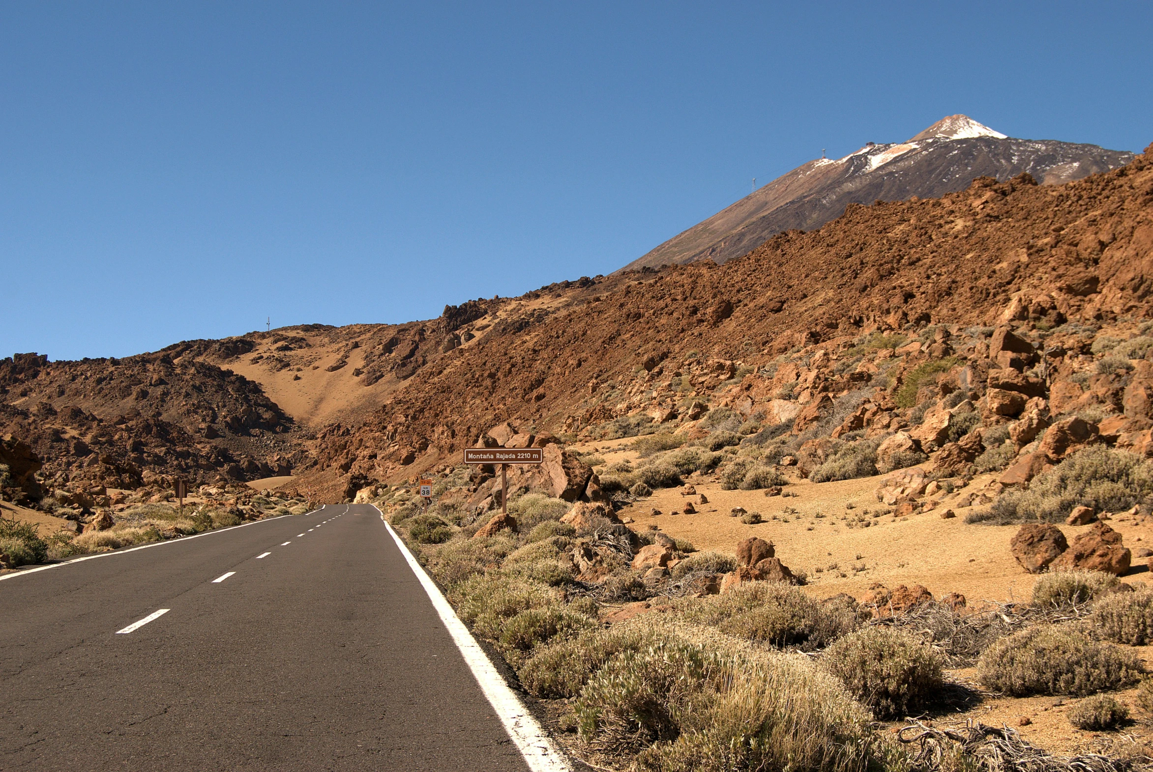 a road running into the distance between two mountains