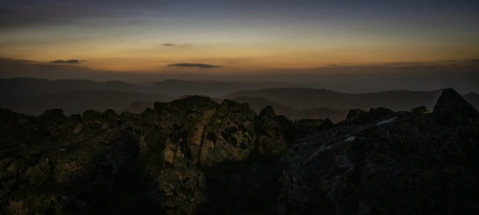 mountains are shown at sunset with a pink sky