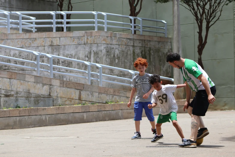 there are three boys riding skateboards and one is talking to each other