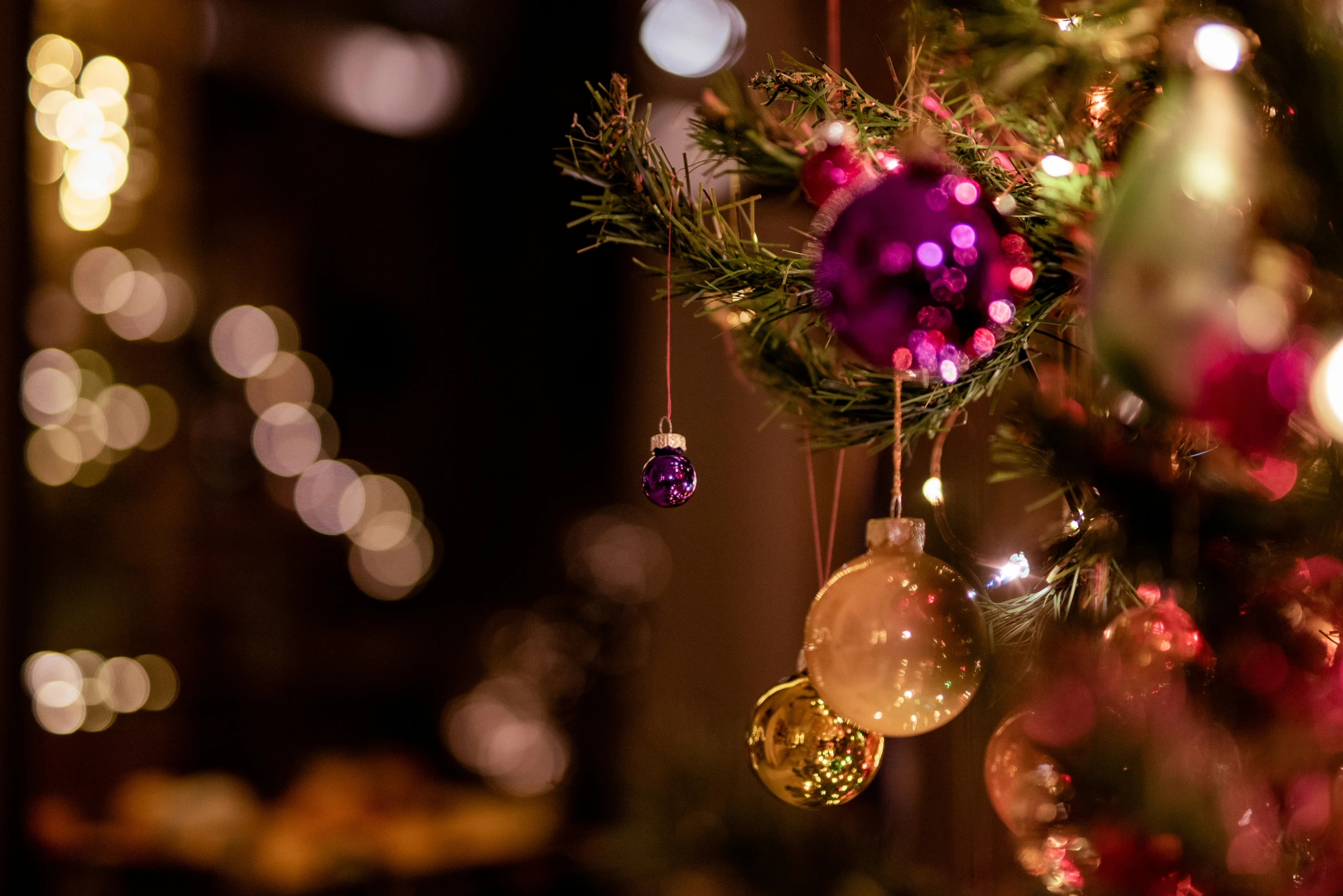 an ornament hanging from a tree next to other ornaments