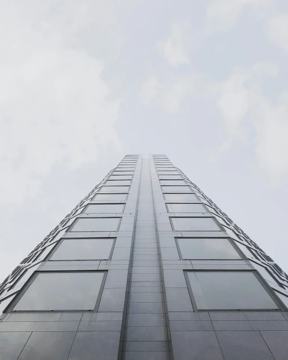 looking up at the side of a glass office building