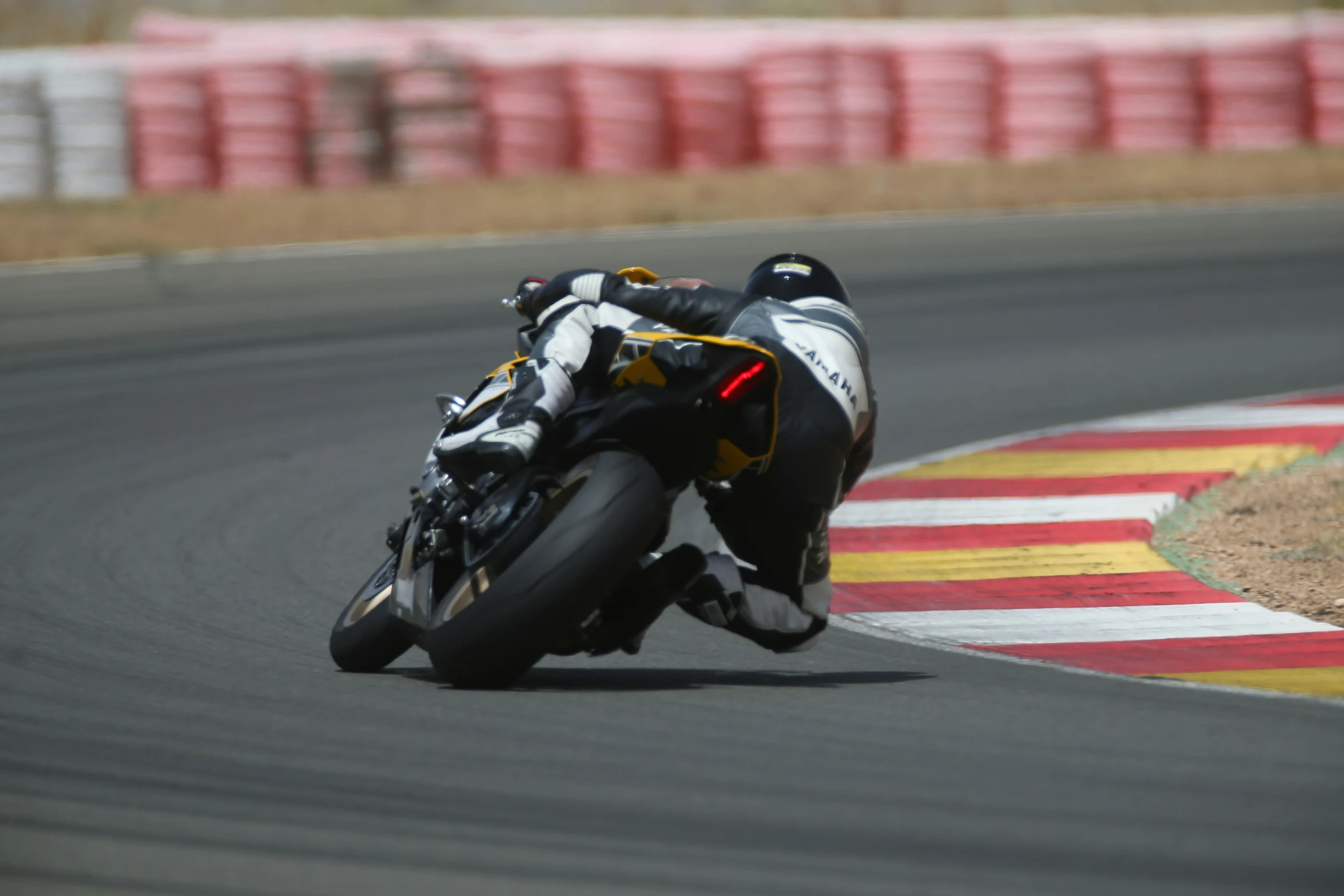 a person riding a motorcycle around a track