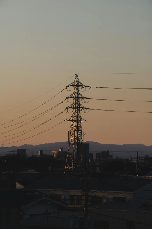 the power lines stand high in the sky above the city