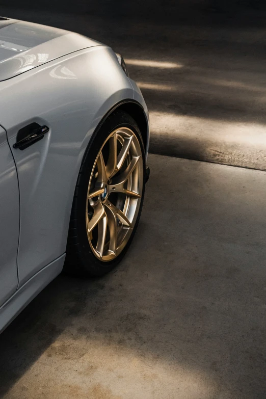 the rims on a car are shiny gold