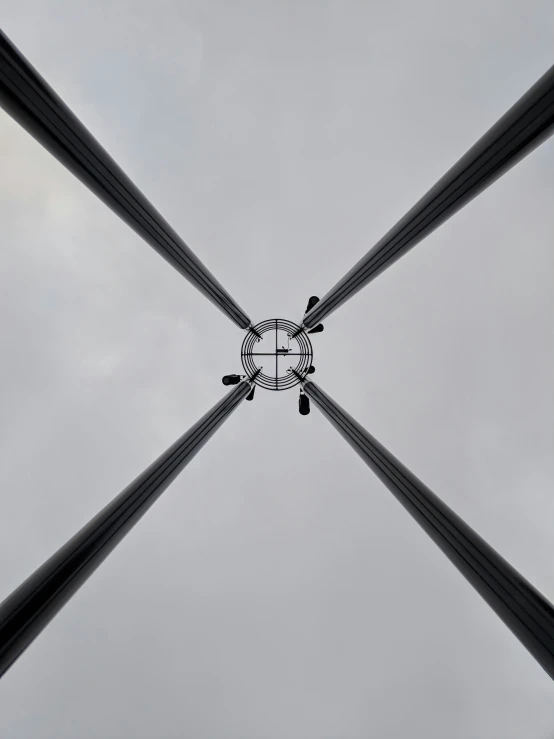 several rectangular objects seen from below against a grey sky