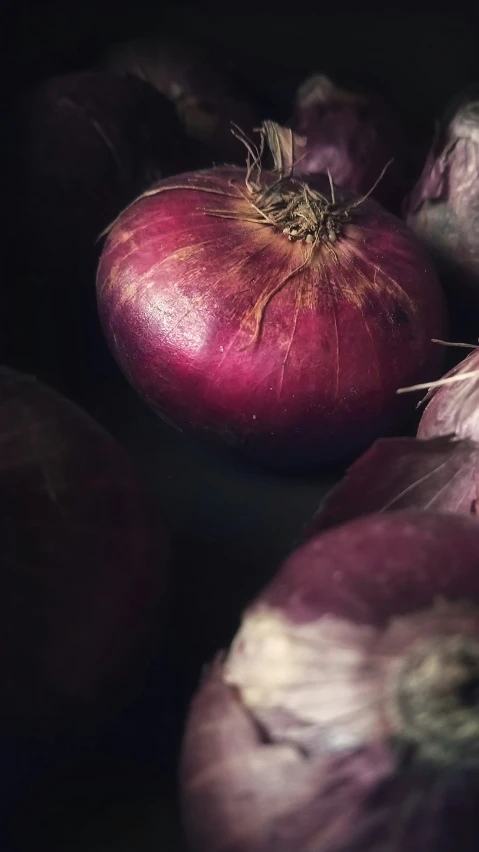 a bunch of red onion bulbs in a pile