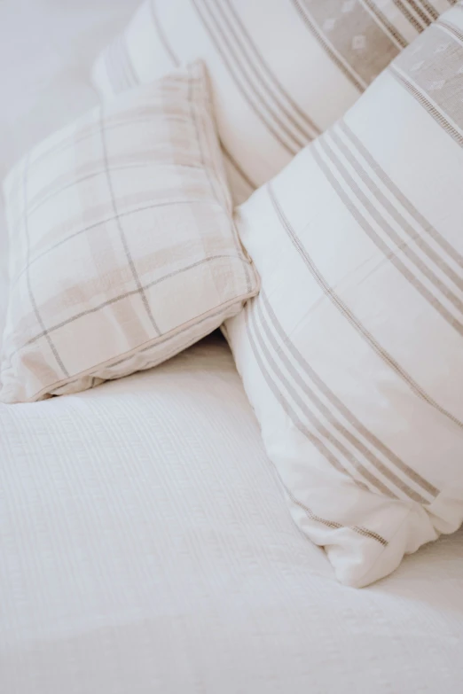 a close up s of several pillows and blanketes