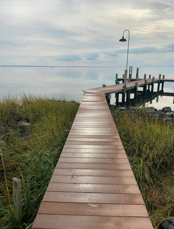 a long wooden walkway that runs from a dock to the water