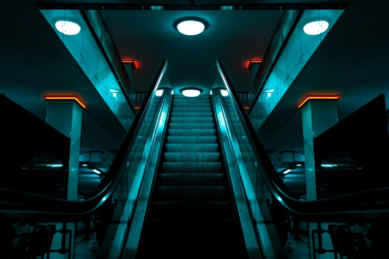 an escalator with stairs in the background at night