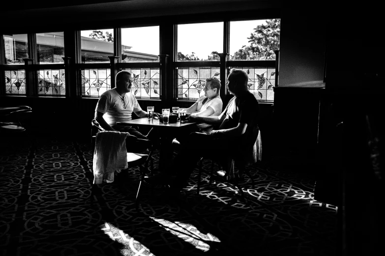 two people in front of a large window on a floor