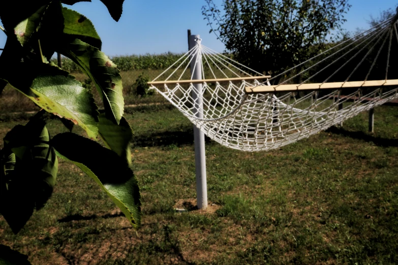 an outside swing that holds the hammock
