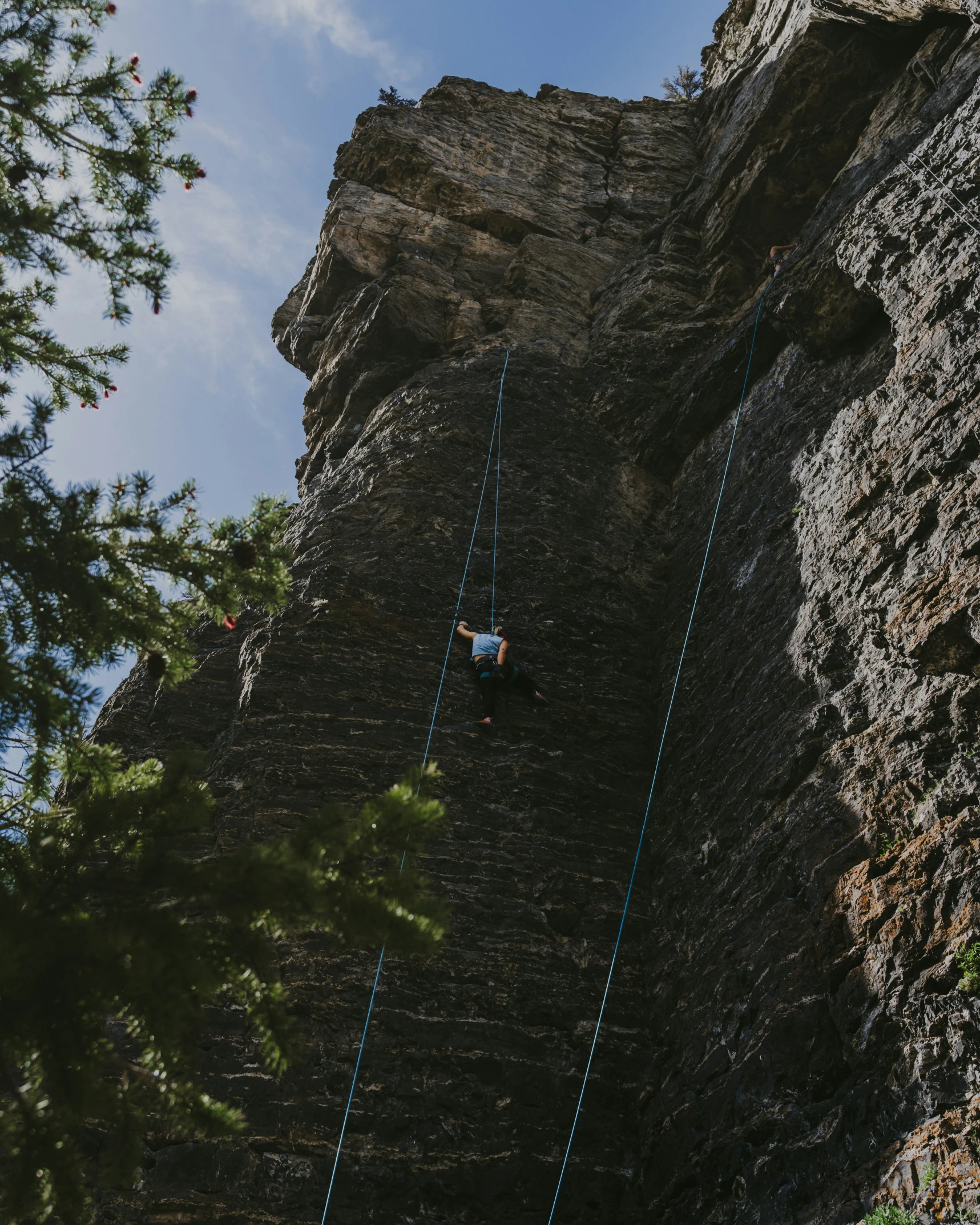 the man is walking up the side of the mountain