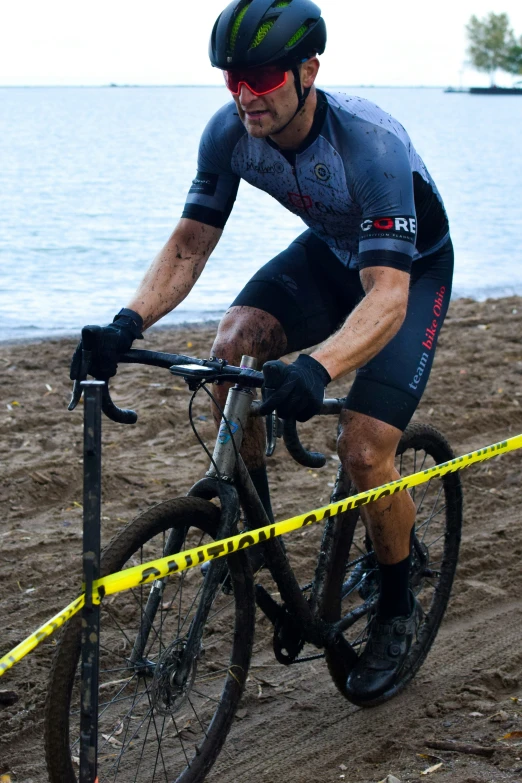 a man is riding a bike on the beach