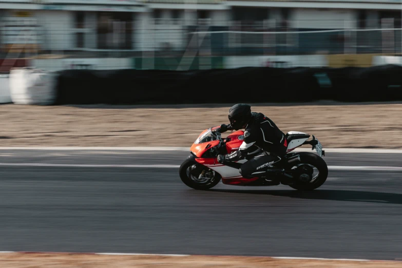 a person rides a motorcycle down the road