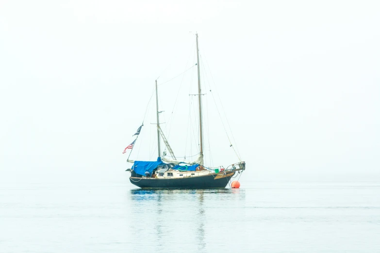 a sail boat is in the calm water