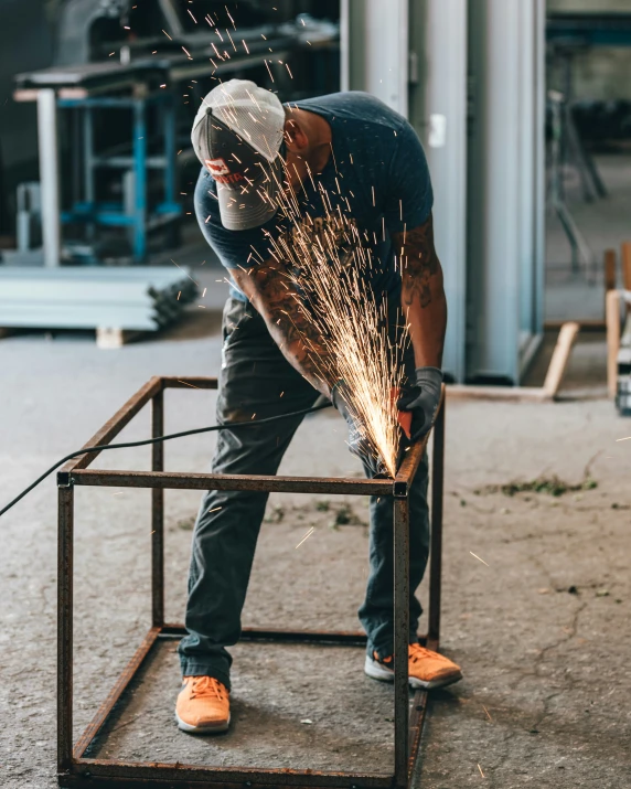 a man welding in his garage in the day time