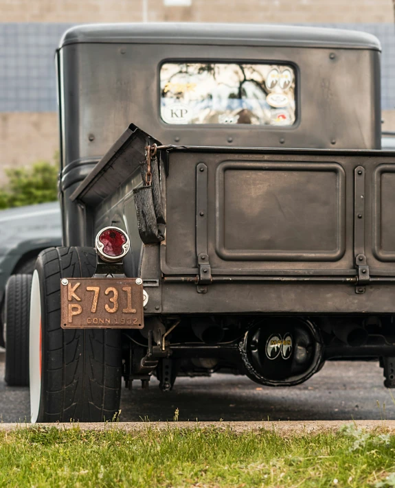 the rear view of an old time black car