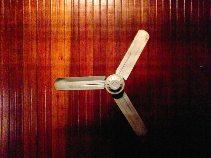 a white fan mounted to the wall in a room