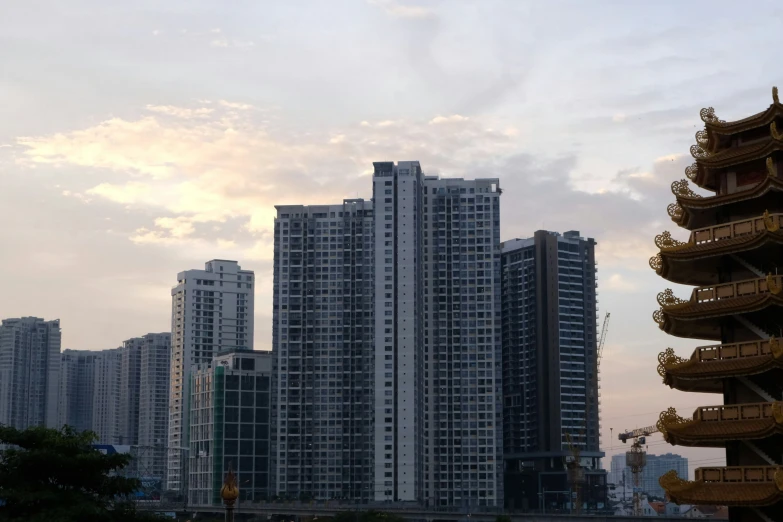 a cityscape is shown against a gray cloudy sky