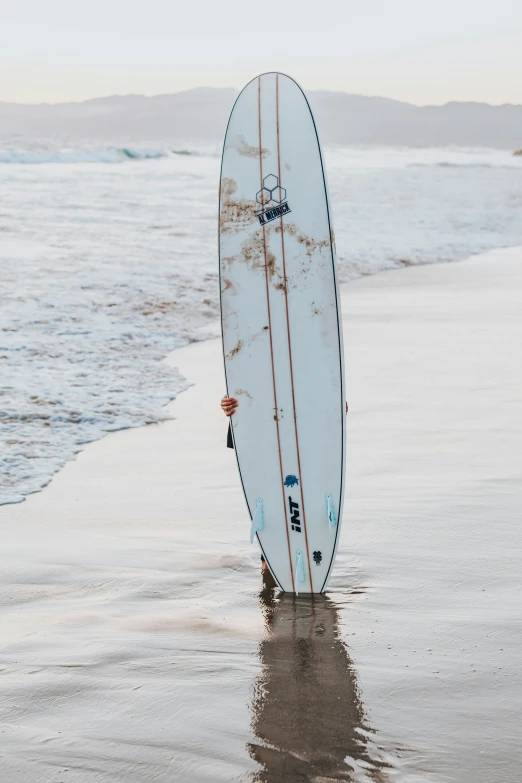 the surf board is standing out in the water